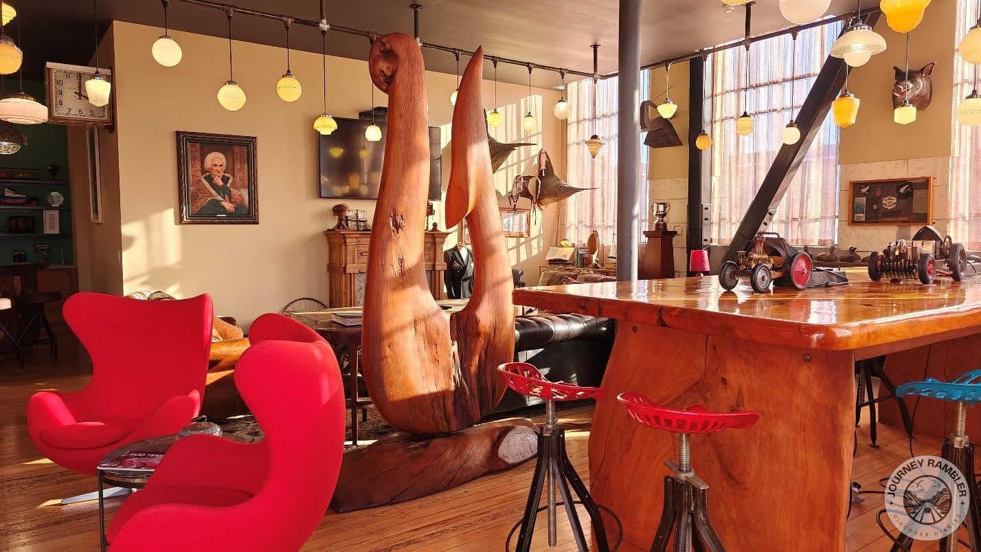 table made from enormous slabs of woods and high stools all around