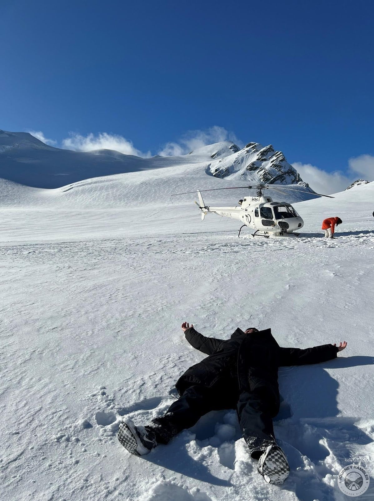 tour participant lying down on snow