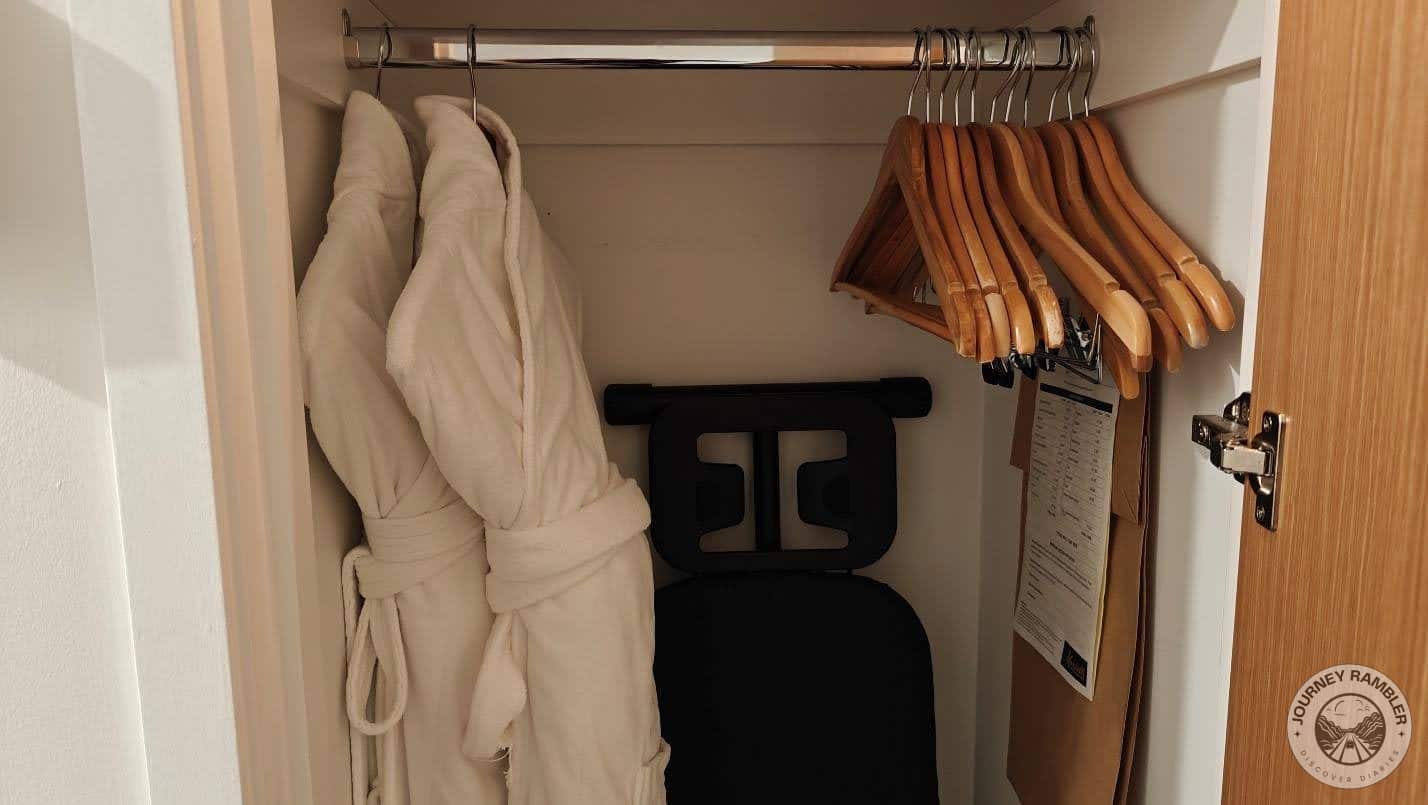 two fluffy bathrobes, a few extra clothes hangers