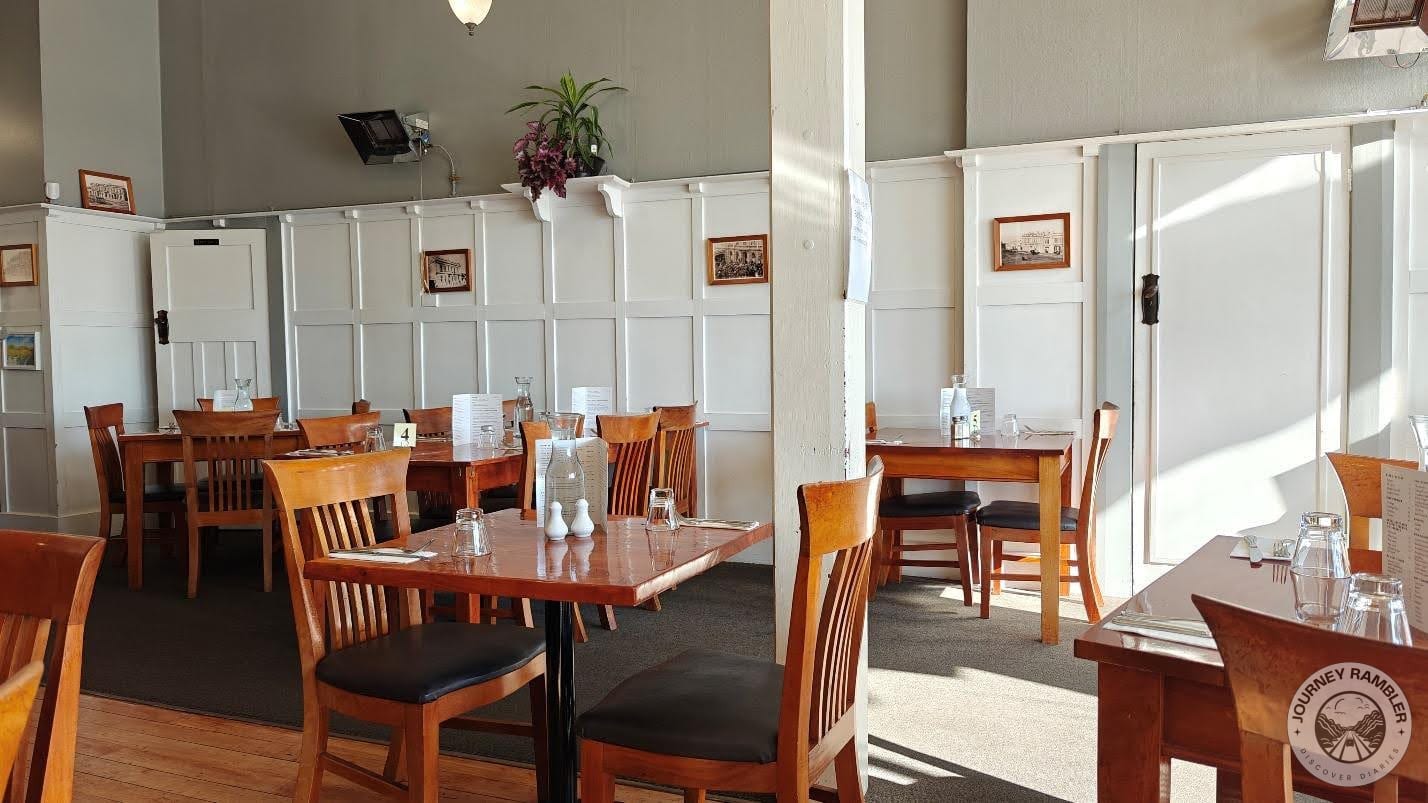 wooden tables and chairs set up for two people or for larger groups