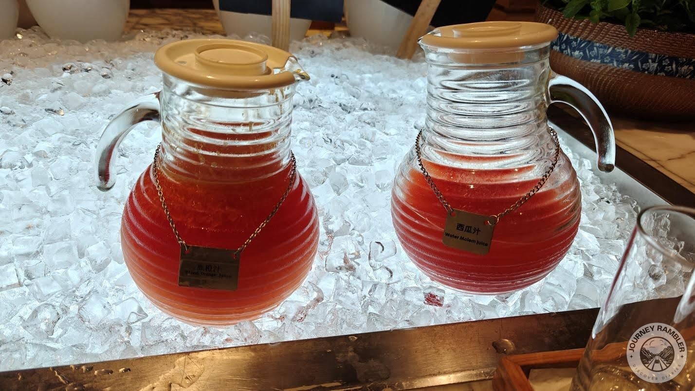 Big glass jars of fresh watermelon juice