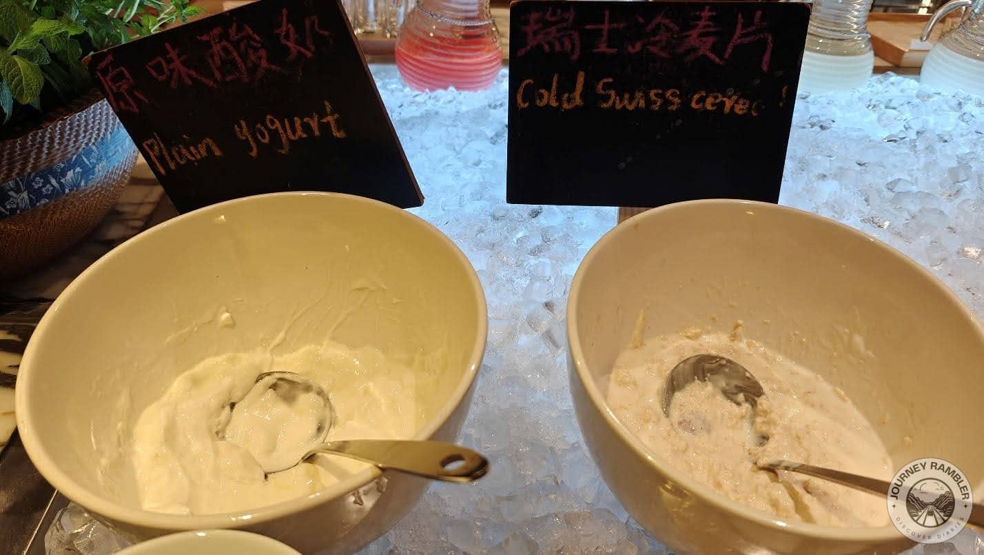 Bowls of plain yogurt and cold Swiss cereal