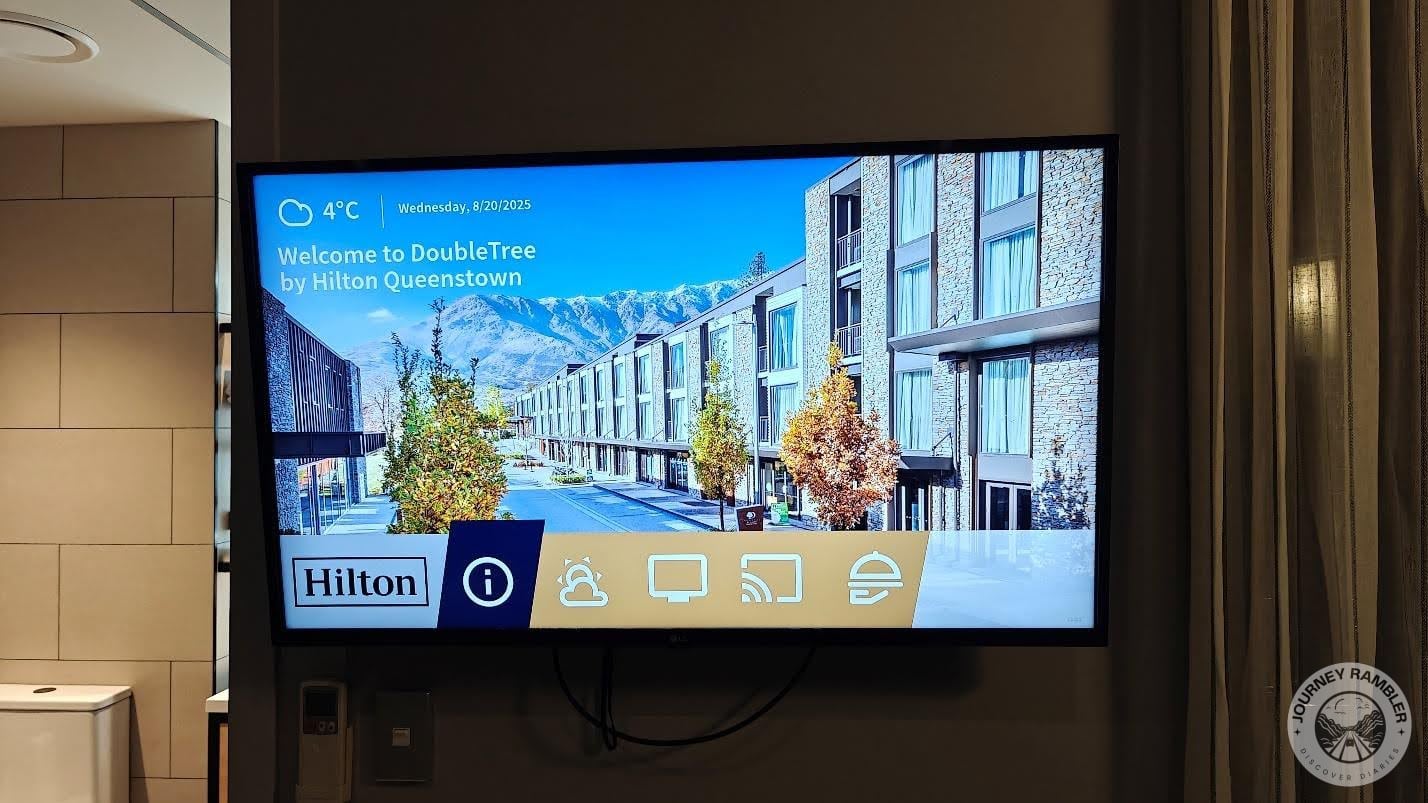 TV screen had a page about the Hilton Hotel welcoming guests