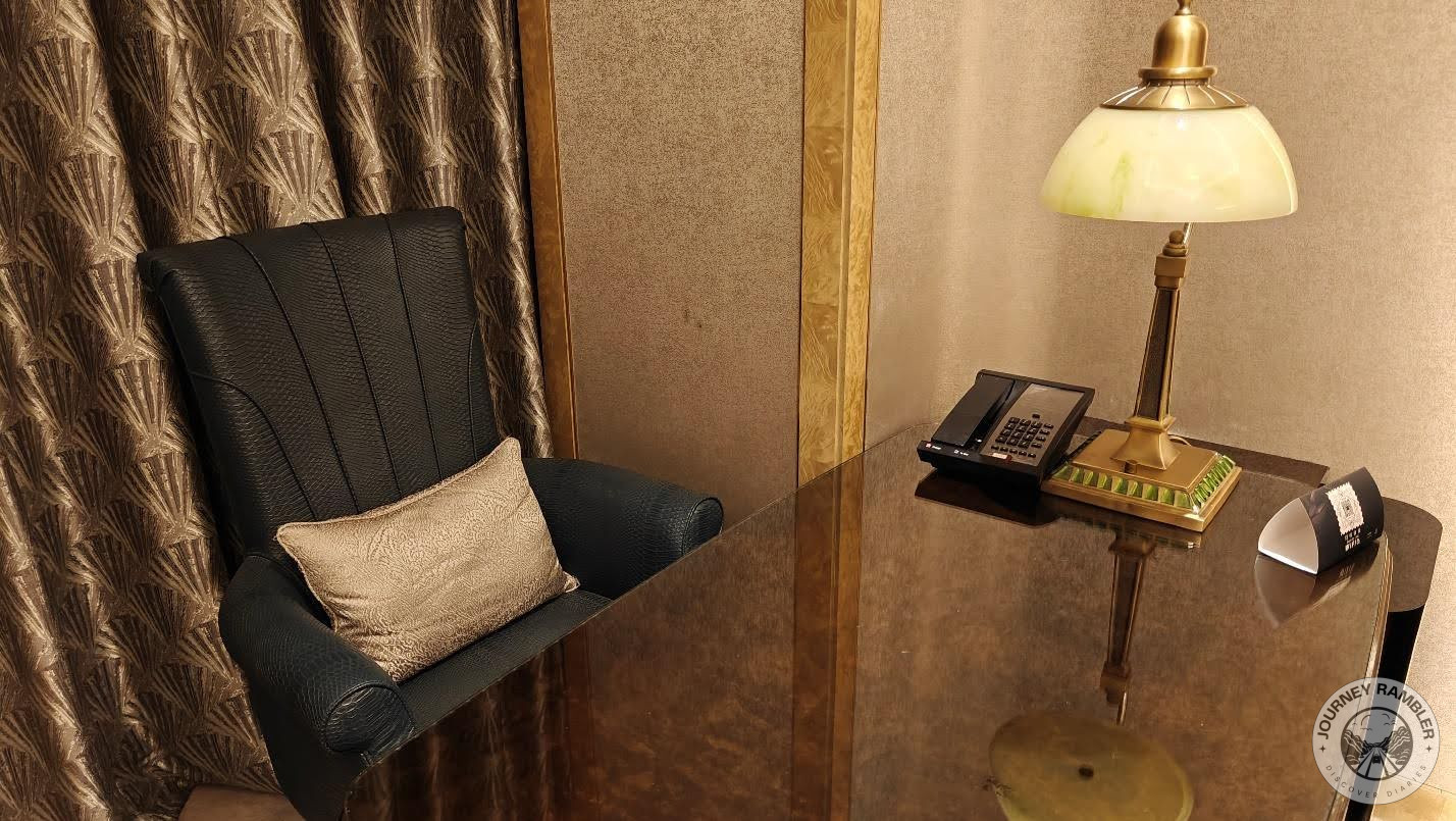 another chair and a big desk in the other corner of the room