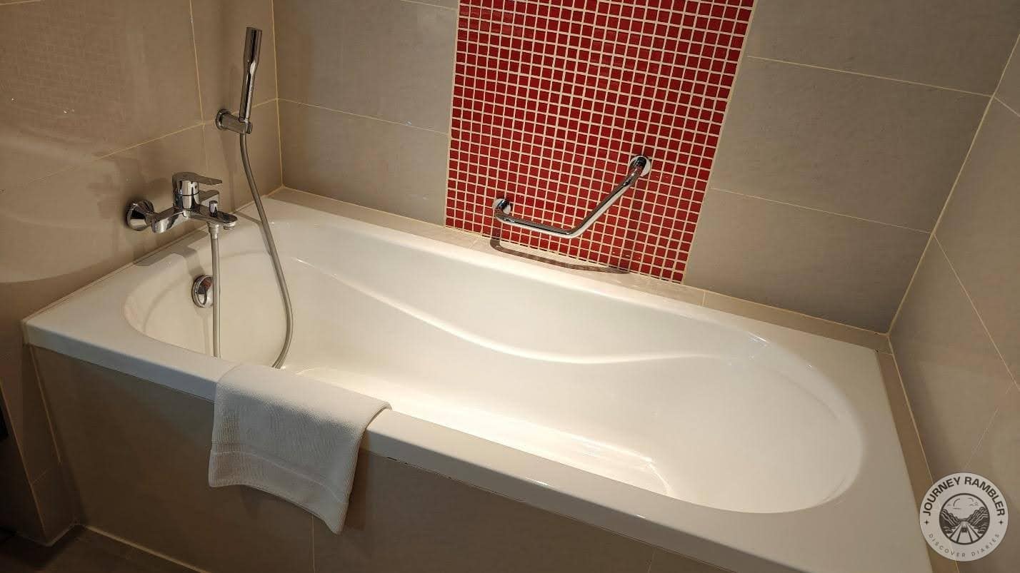 bathtub with a hand shower