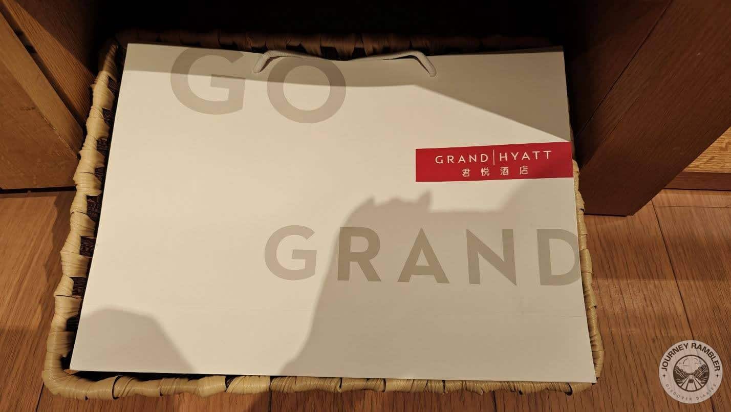 big paper bag with the logo of the Grand Hyatt Hotel