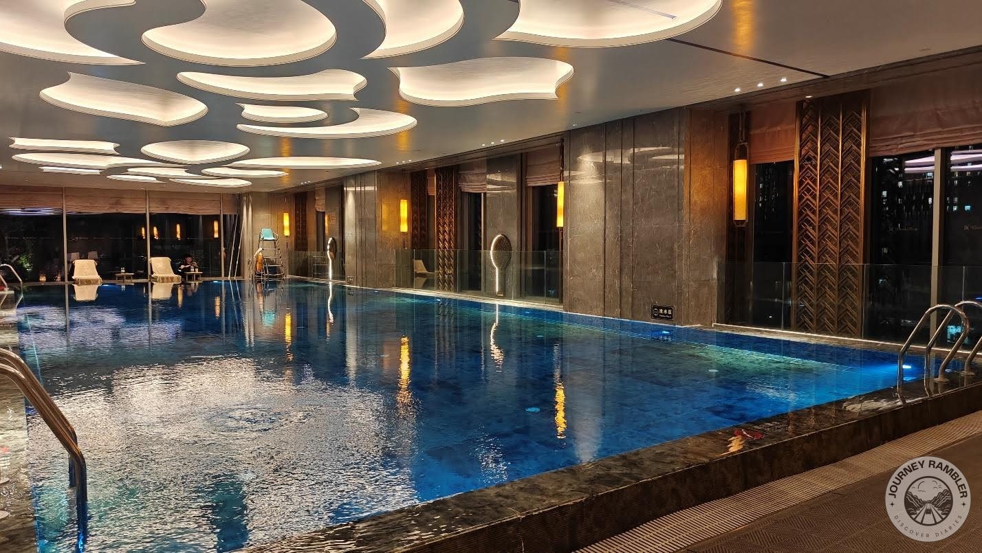 big, rectangular pool and was tiled with bright blue tiles at the bottom