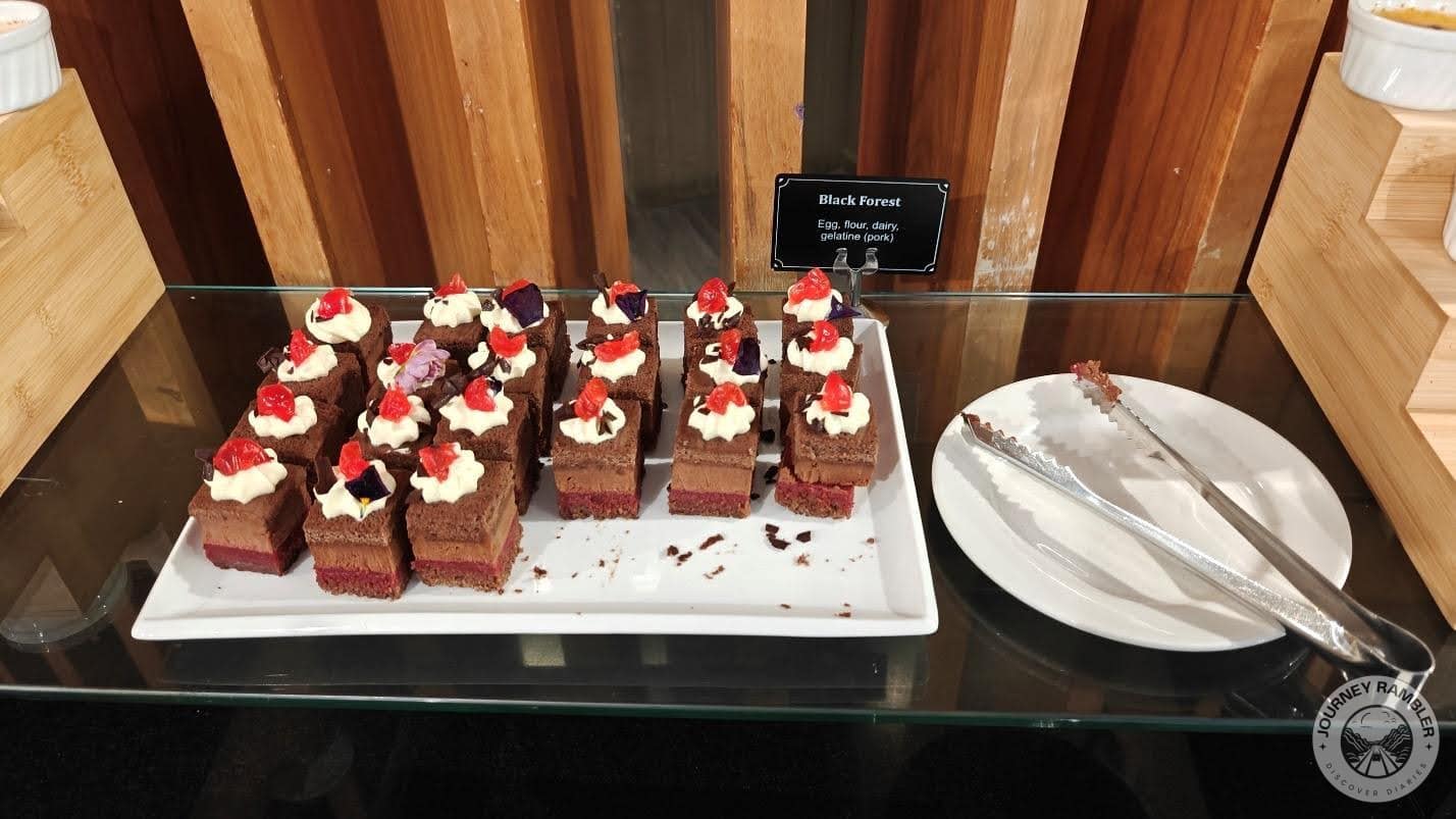 black forest cake slices, each topped with cream and a cherry