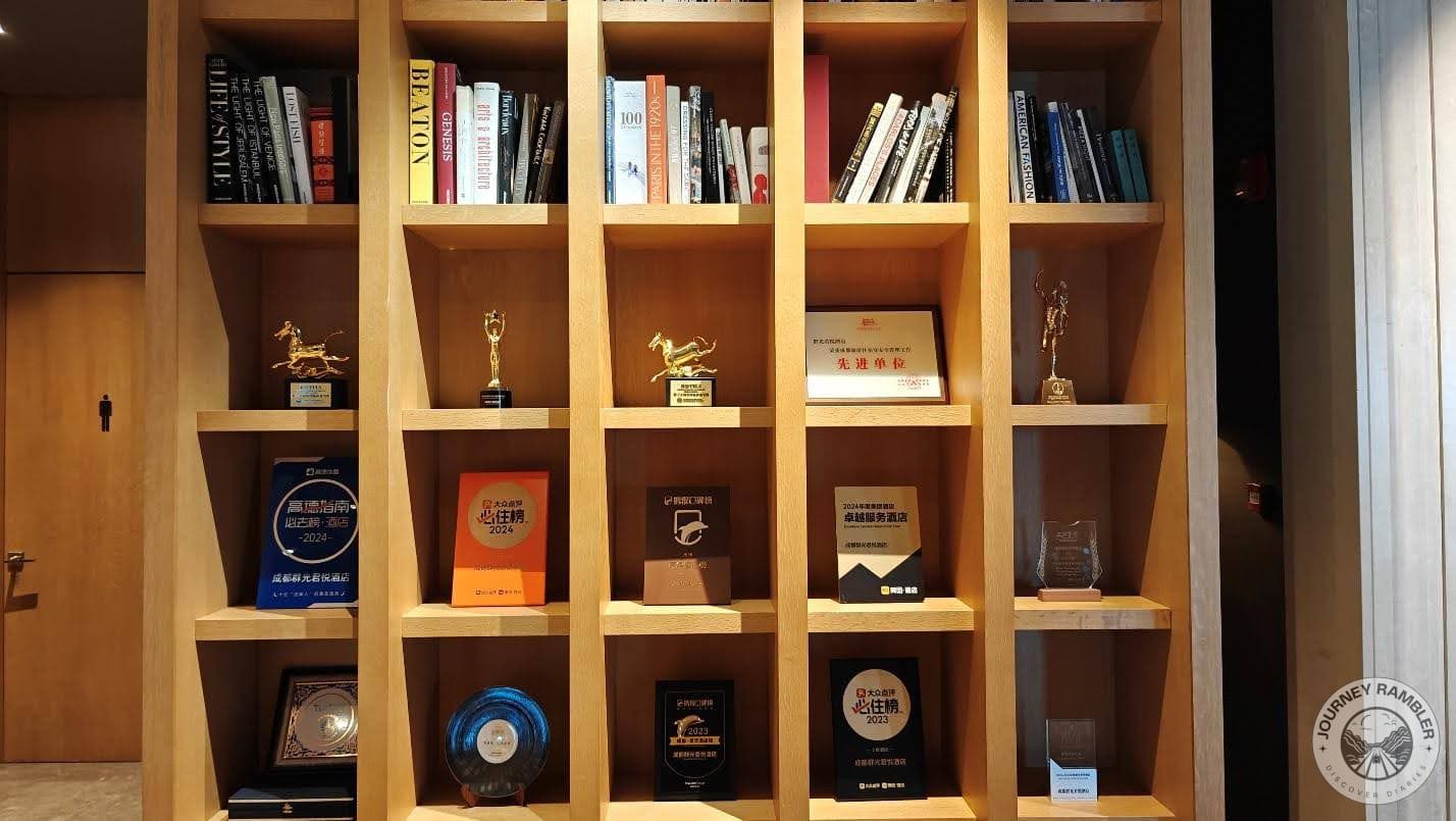 bookshelf filled with books and awards