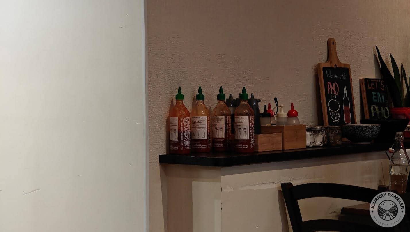 bottles of sauce and other condiments sitting on the counter