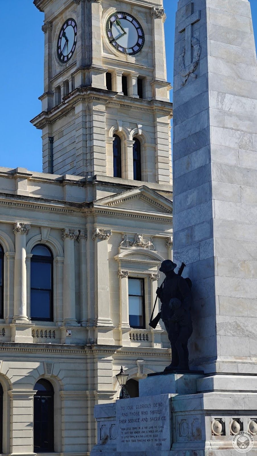 bronze statue of a soldier consoling a small child