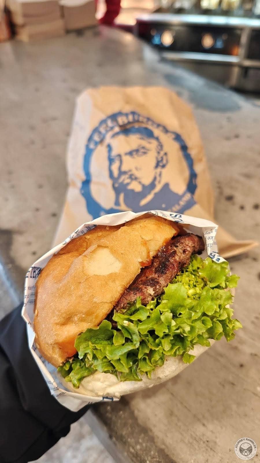 burger also had a lot of lettuce, tomato, red onion, tomato relish and aioli