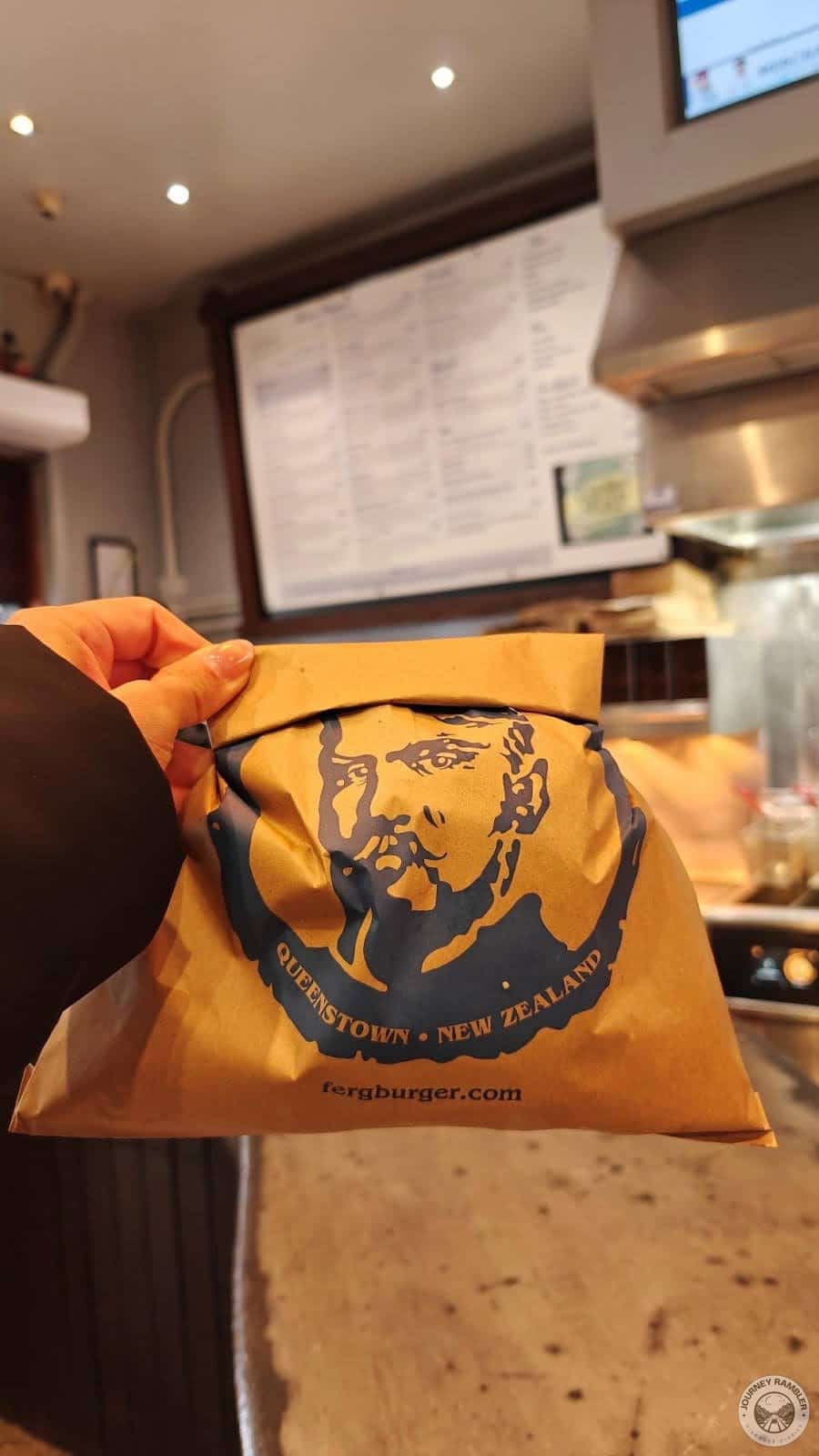 burger in a brown paper bag