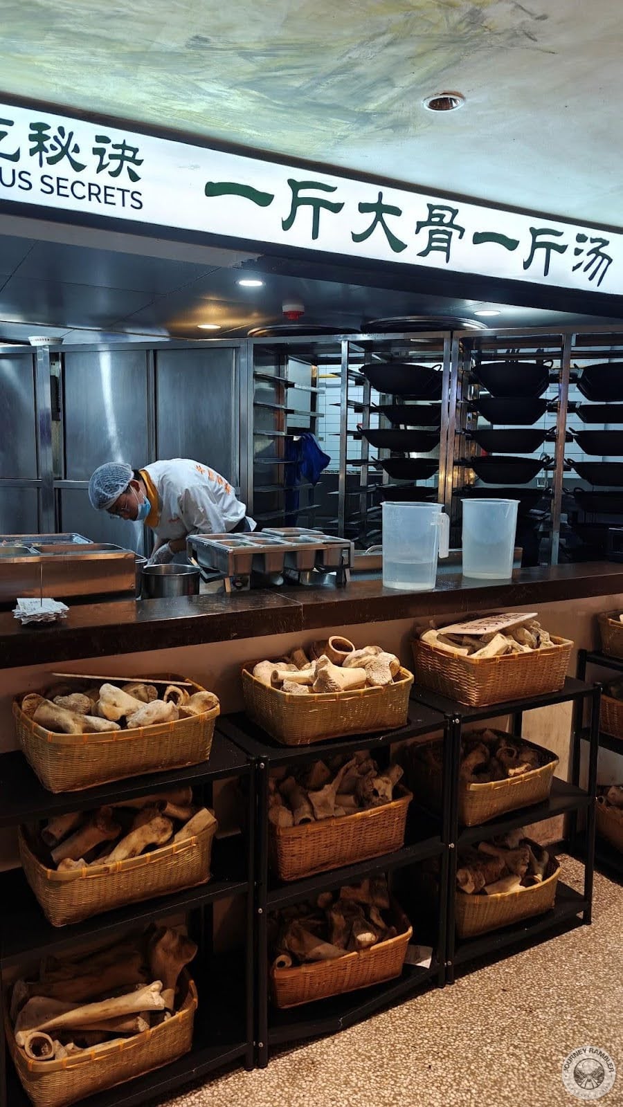 chefs were all working and there were baskets full of what looked like bones in front of the kitchen