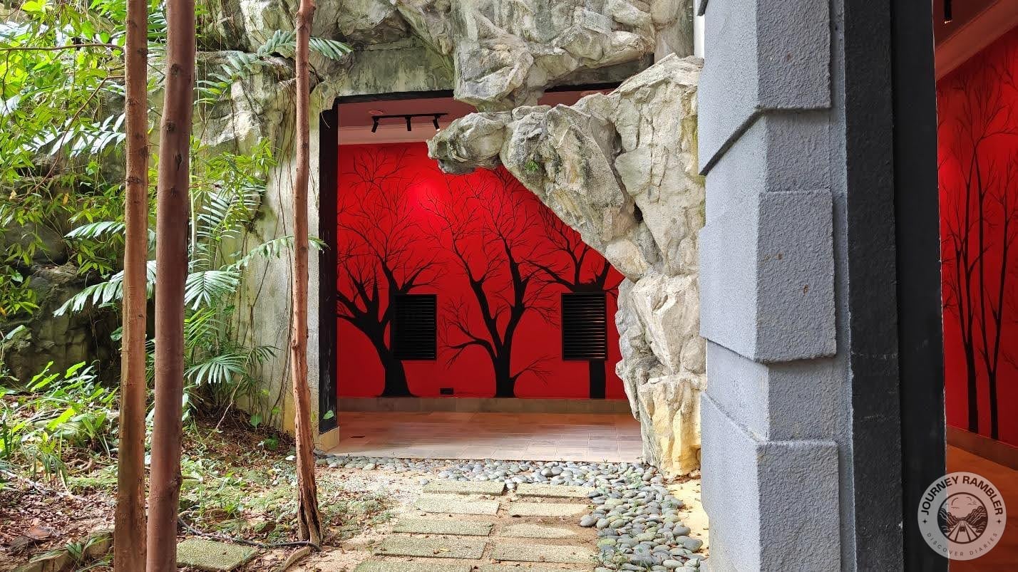 corridor had been painted bright red and it also had silhouettes of trees painted all along the walls