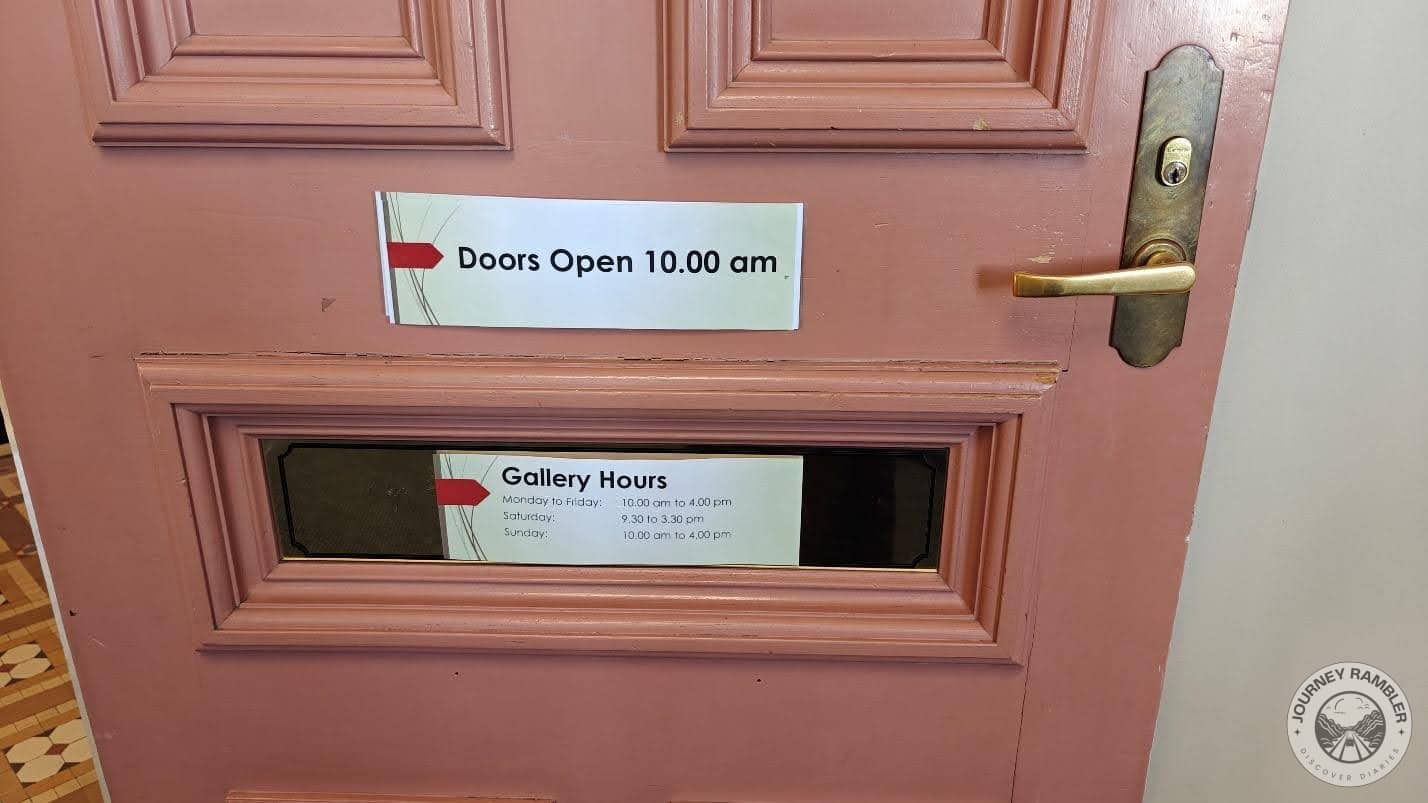 couple of signs on the door of the gallery