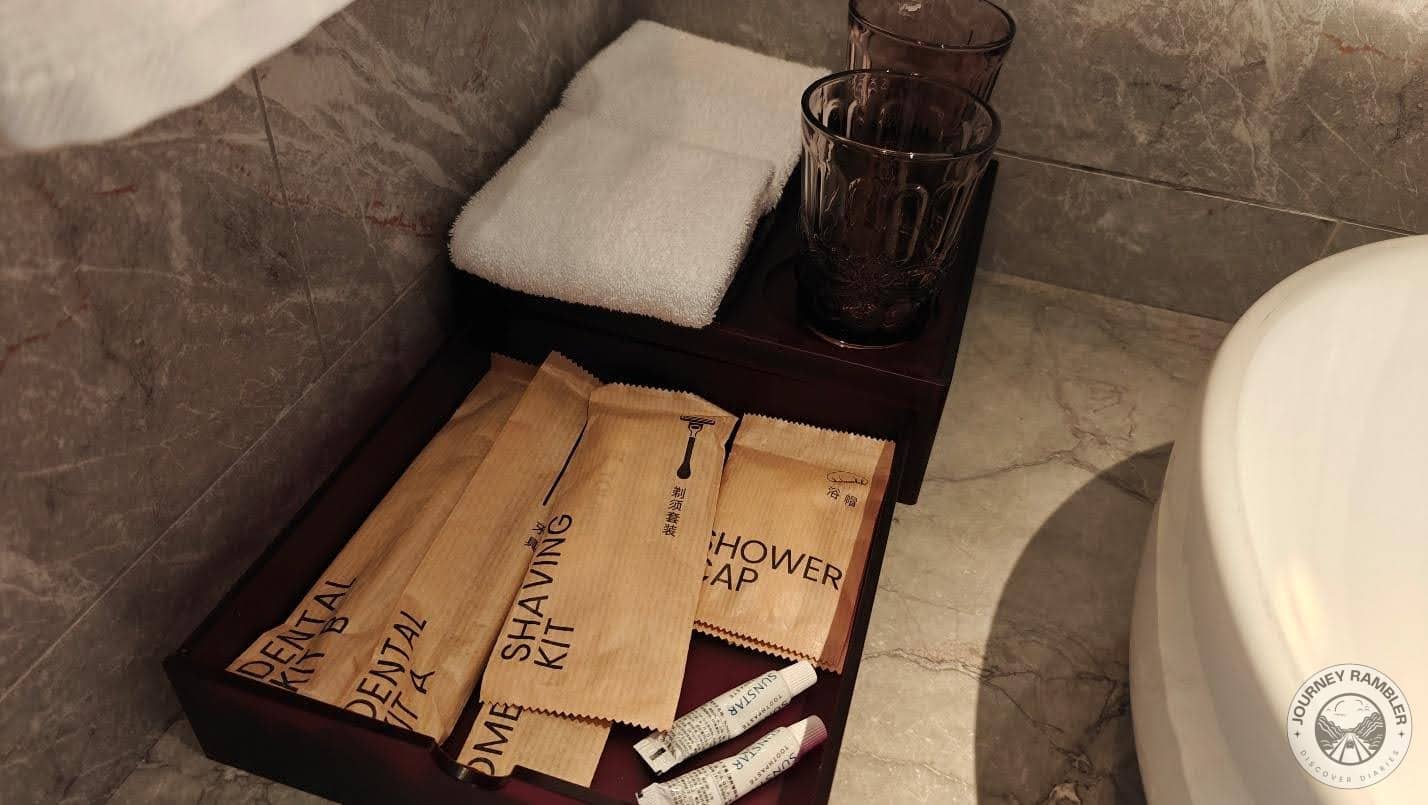 dental kit, shaving kit, shower cap and small hand towels