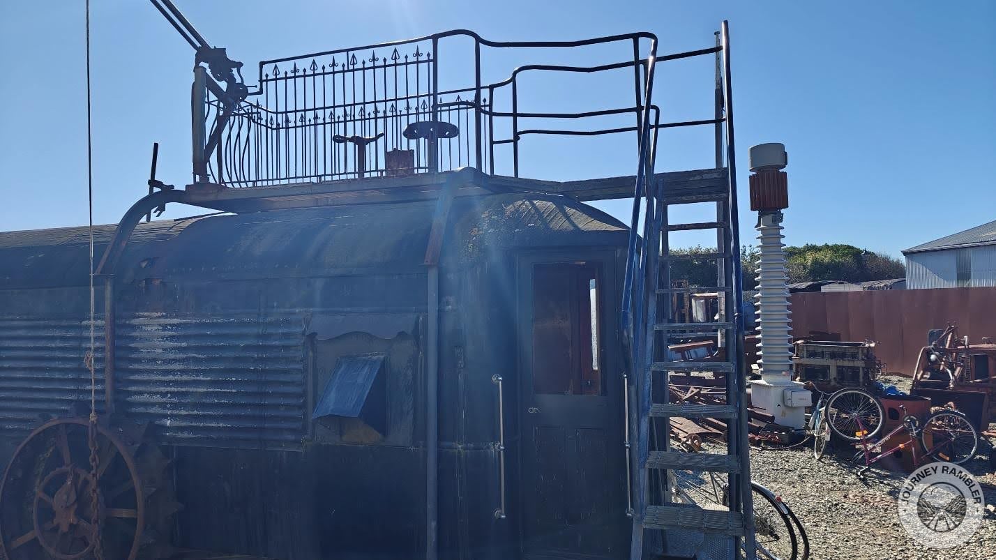 dilapidated train car which has a view deck welded on top of its roof