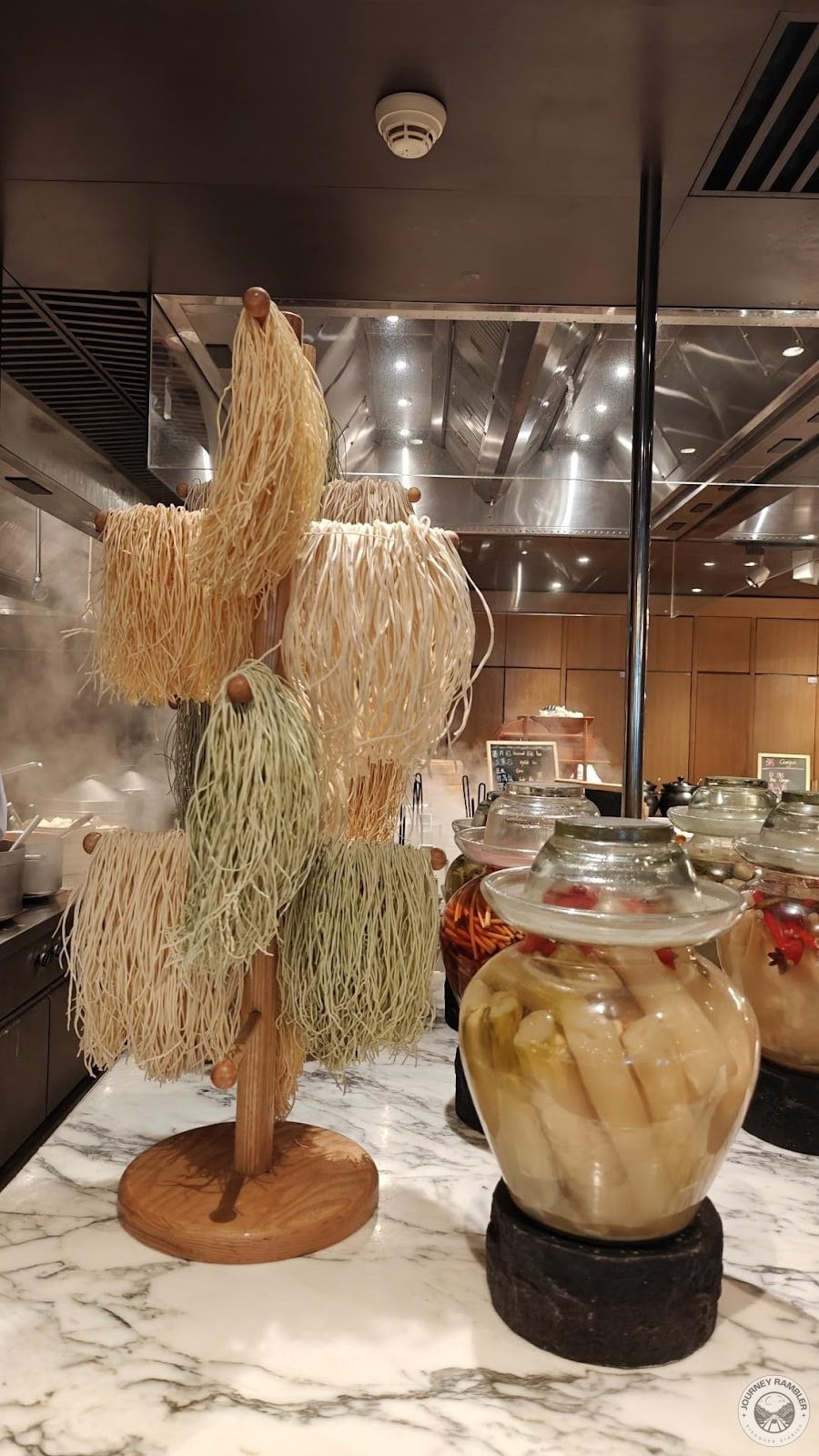dried noodles hanging from a big drying rack