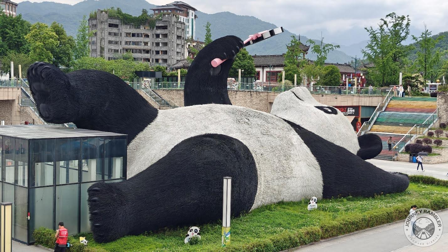 giant statue of a panda holding a selfie stick