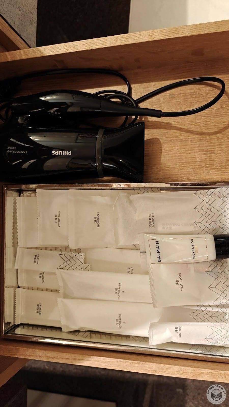 hairdryer along with other toiletry items