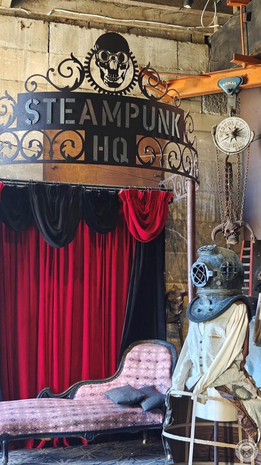 huge stand with the building’s name and an old diving helmet on top of what looks like Victorian clothing