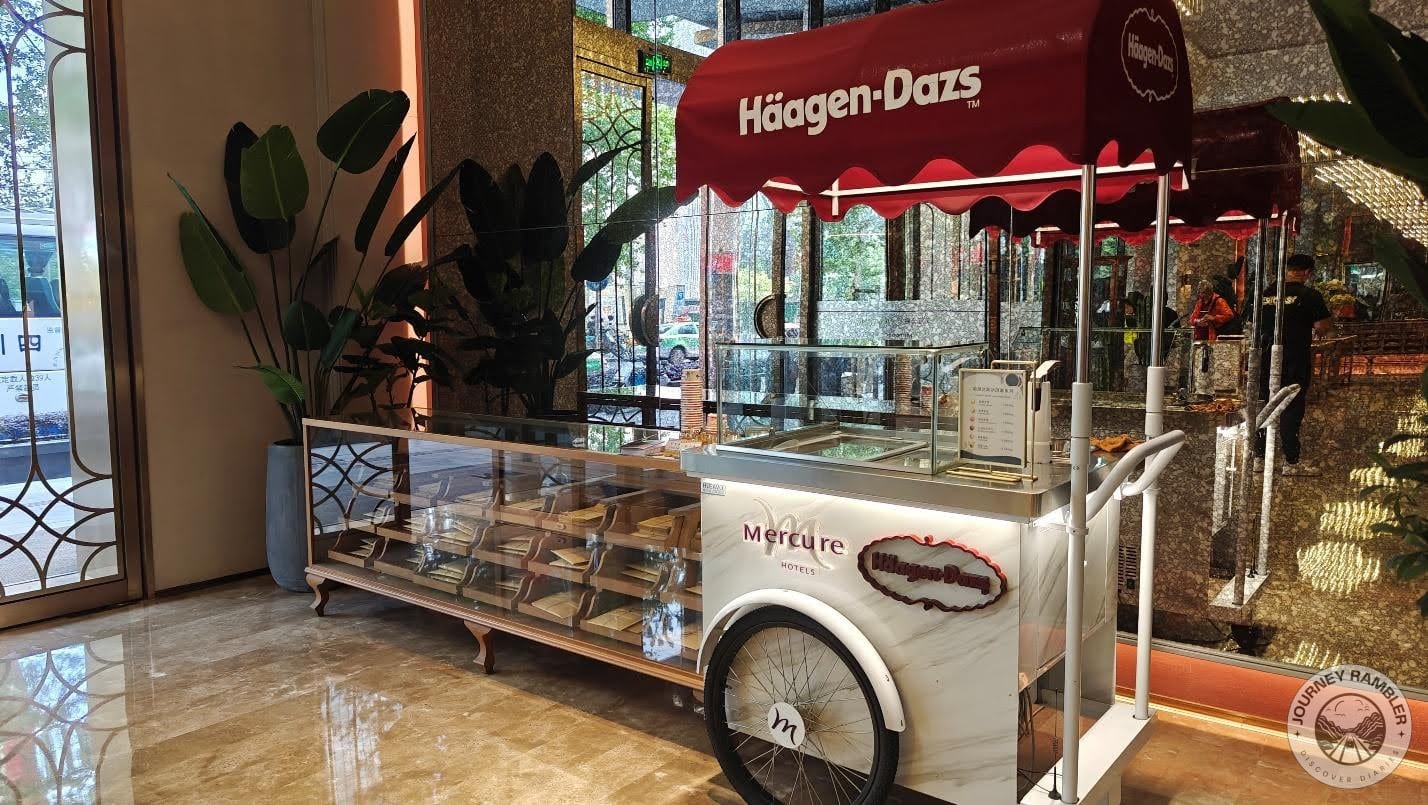 ice cream cart right next to the entrance and some bakery shelves next to that