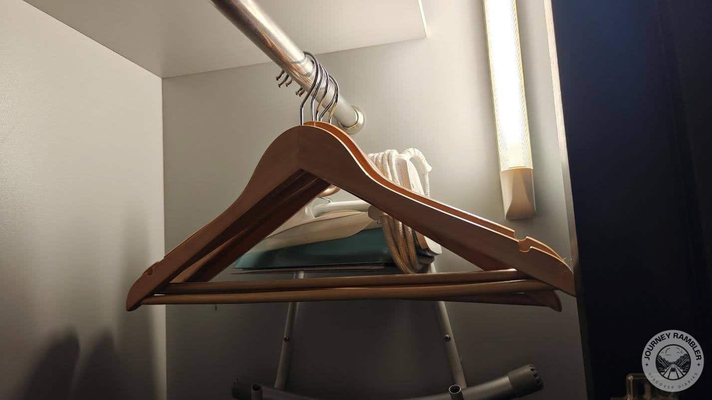 iron was kept on a small shelf on one side of the closet