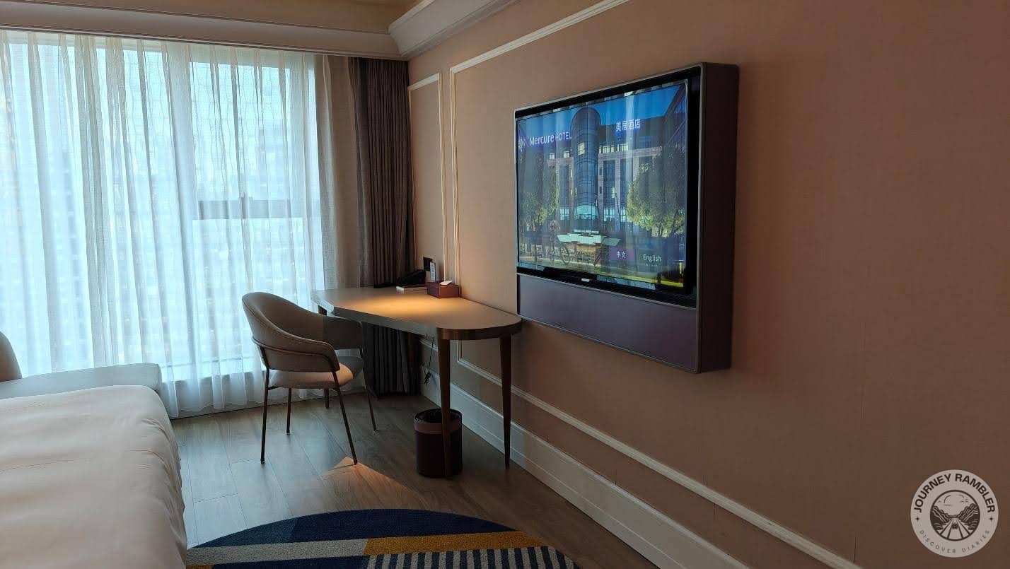 large screen TV right opposite the bed