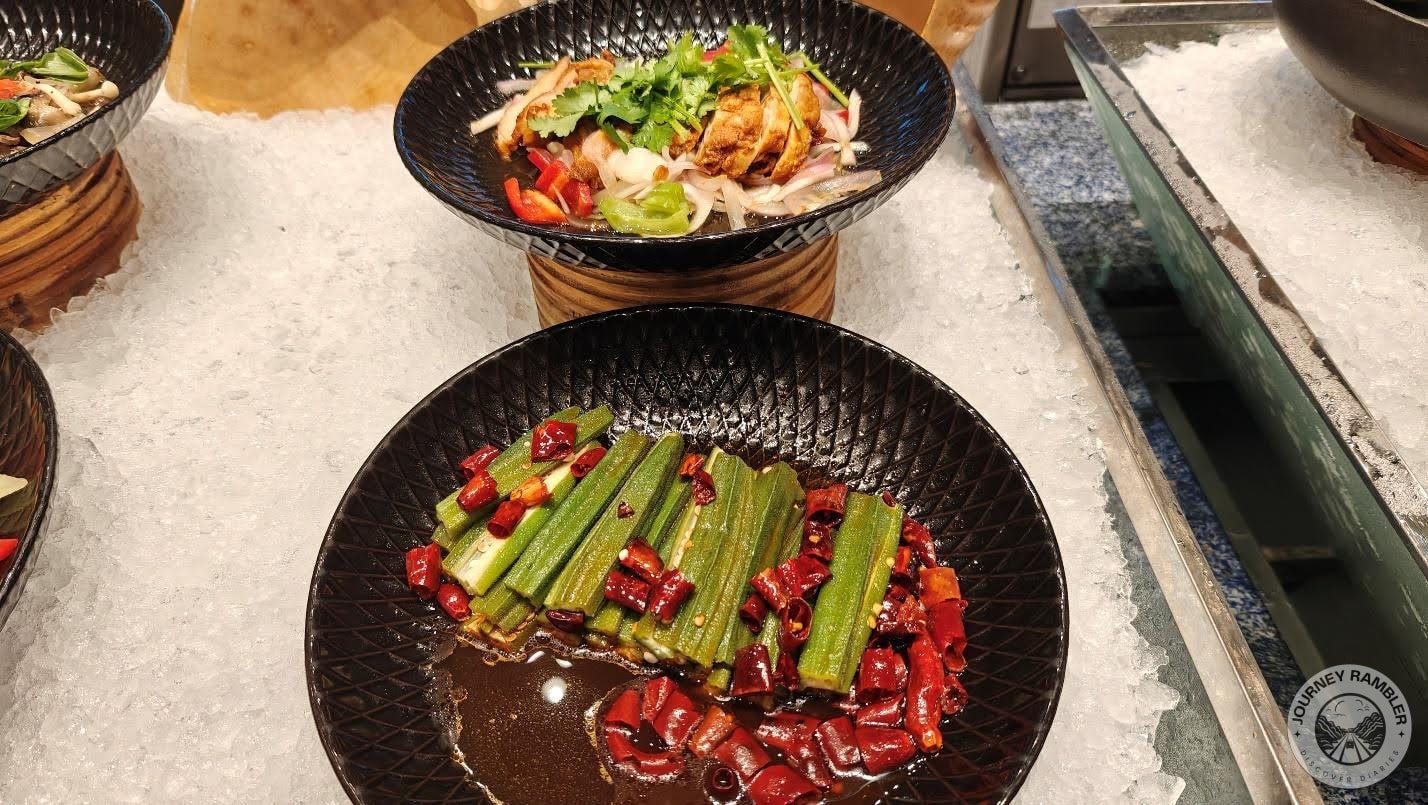 one salad with chicken and another with red pepper slices and okra