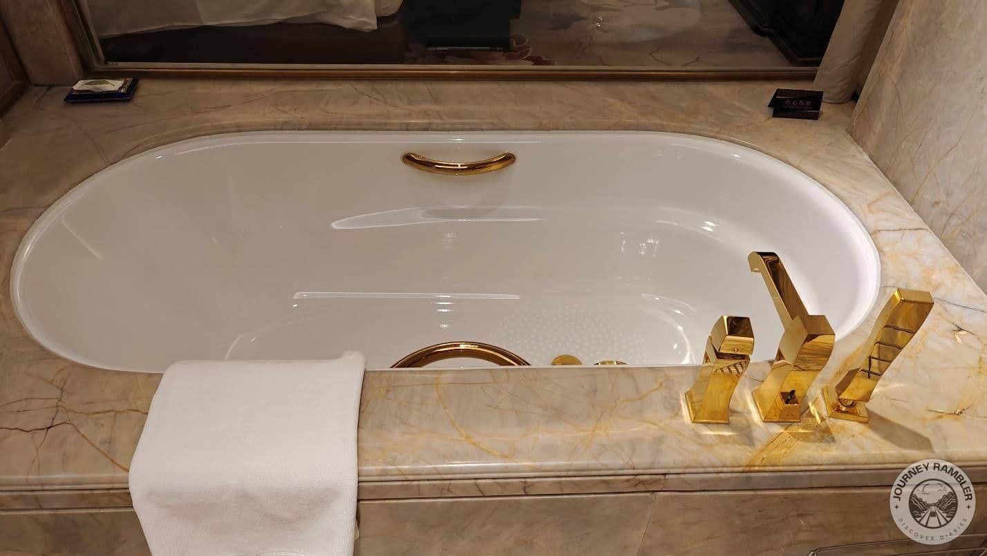 oval bathtub and all the taps and bathroom fittings were a rich gold color