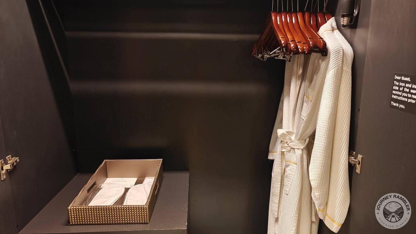 pair of white bathrobes hanging inside the closet