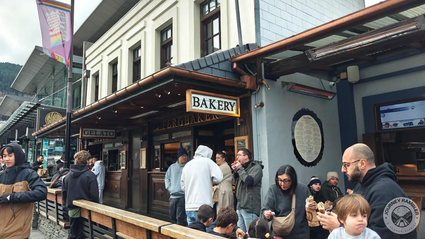 people lined up outside the bakery with pastries and pies in their hands