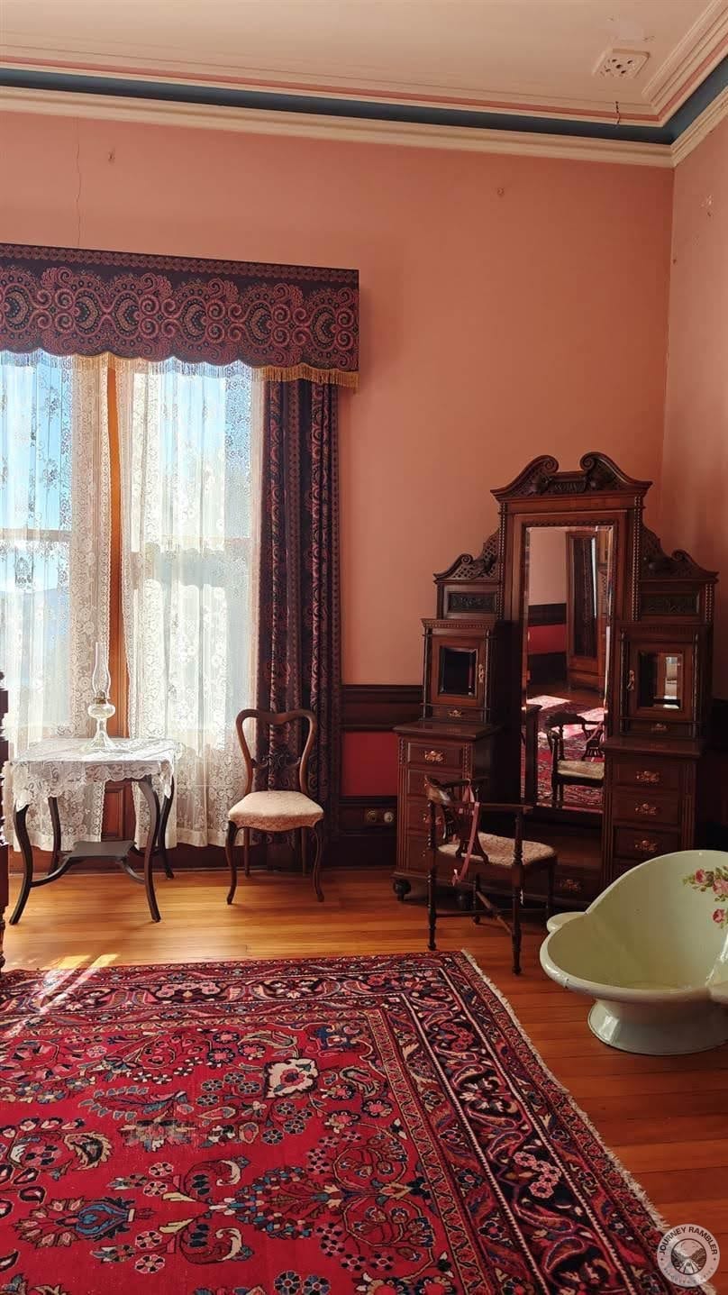 presence of a cabinet with a vanity mirror also suggests that a woman might have been the room’s resident