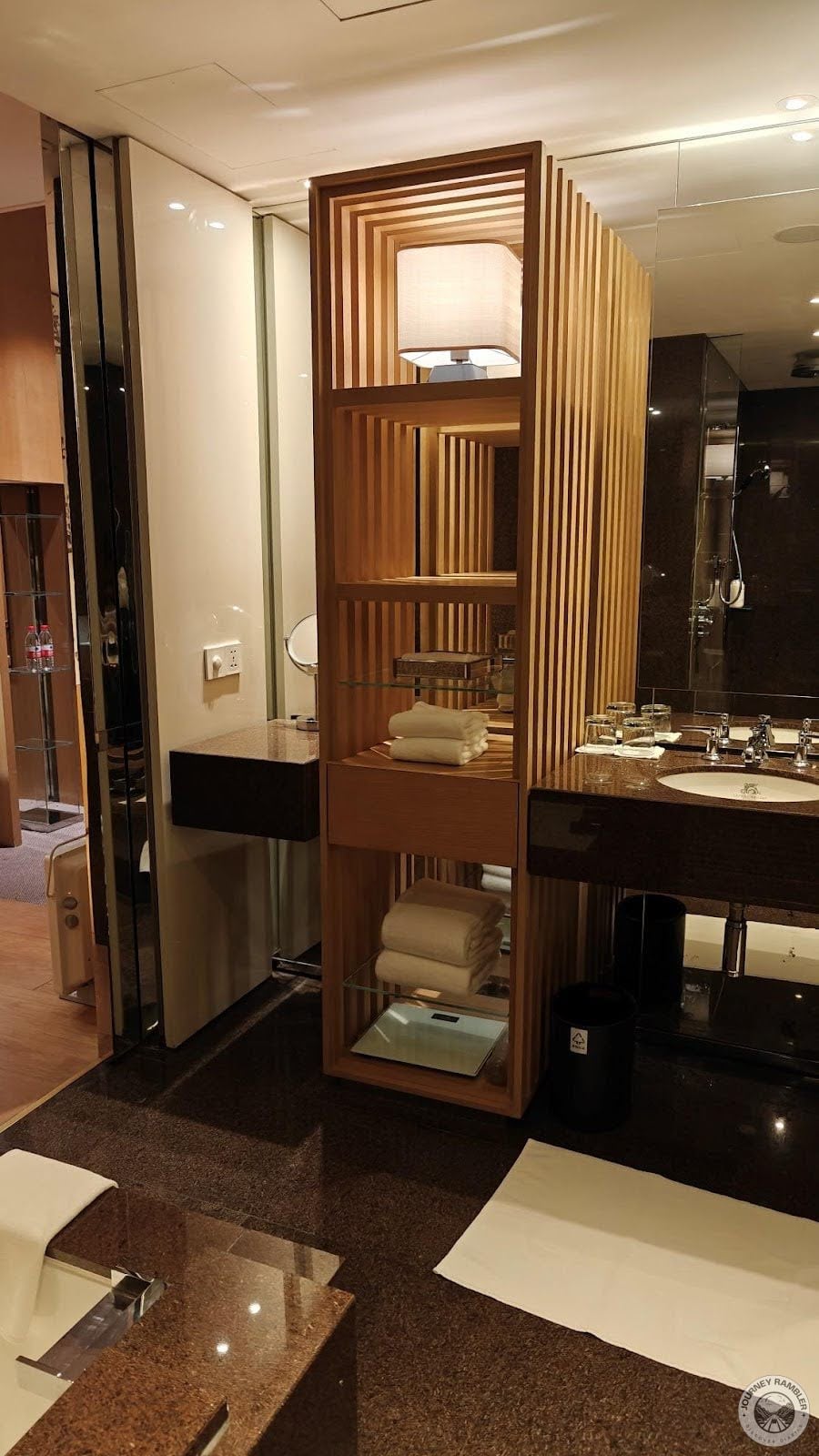 row of shelves between the vanity counter and the washbasin
