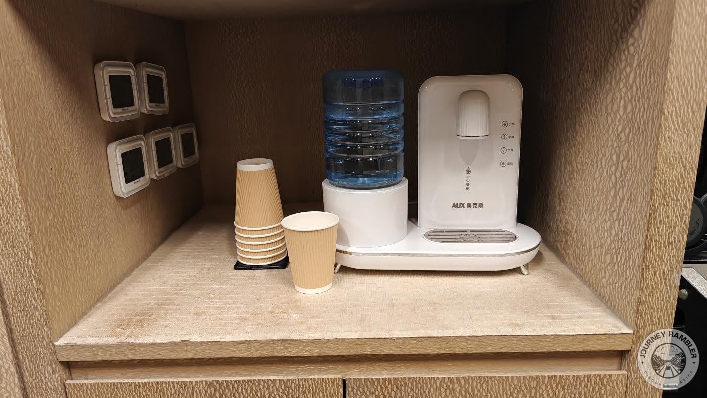 set of paper cups sat beside the water container