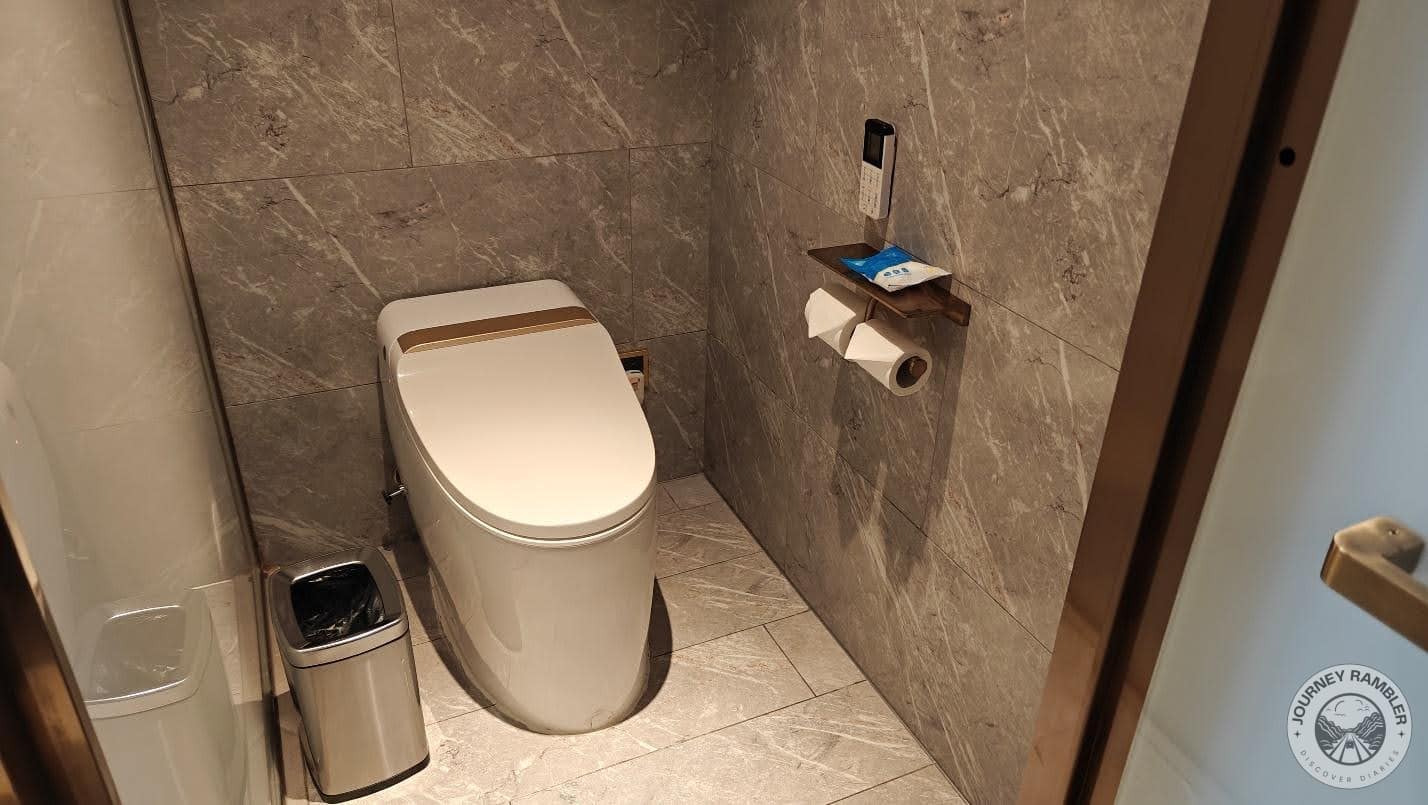 shower and toilet areas were tiled with some grey marble