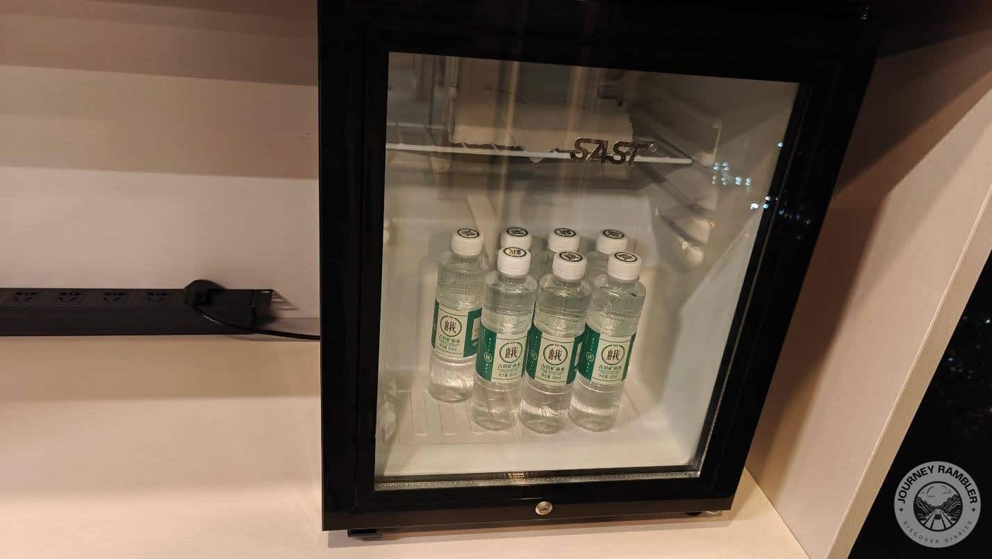 small fridge filled with bottles of water