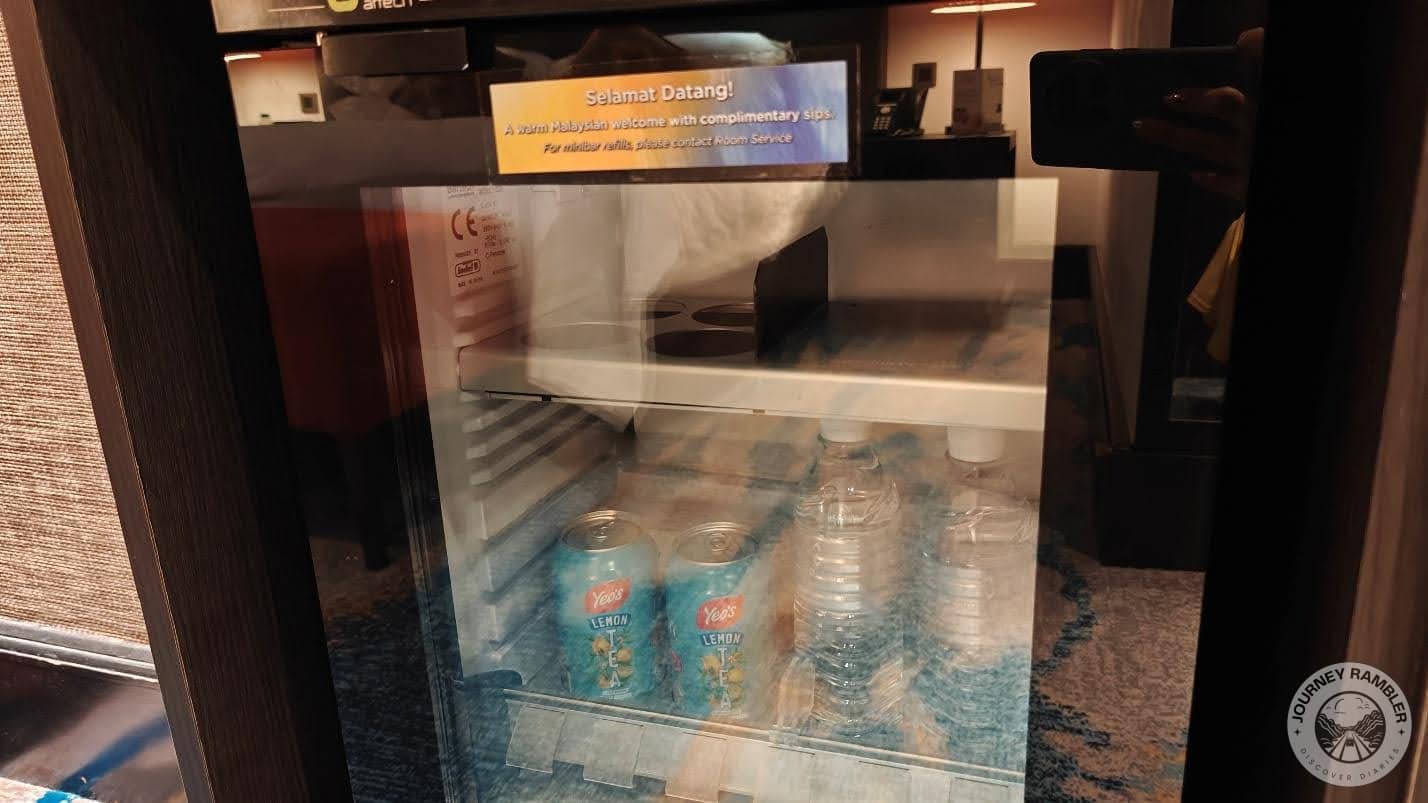 small refrigerator not only had some ice cold water but also cans of juice