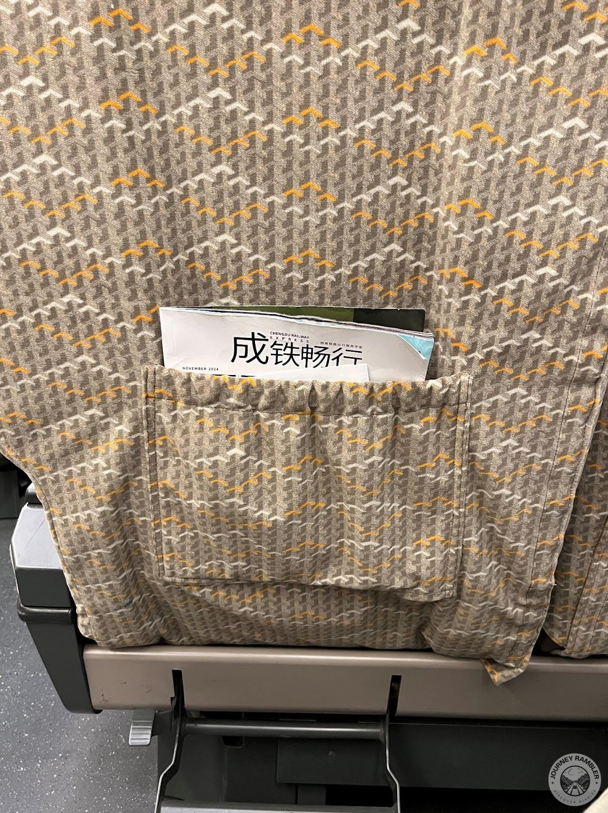 some magazines in the pocket of the seat before me