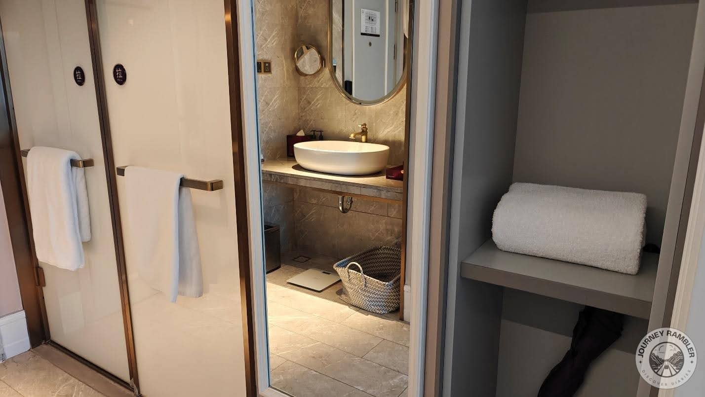 some shelves beside the bathroom where extra towels had been stored