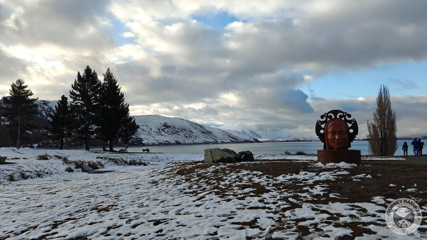 statue of a lady’s head on the banks of the lake