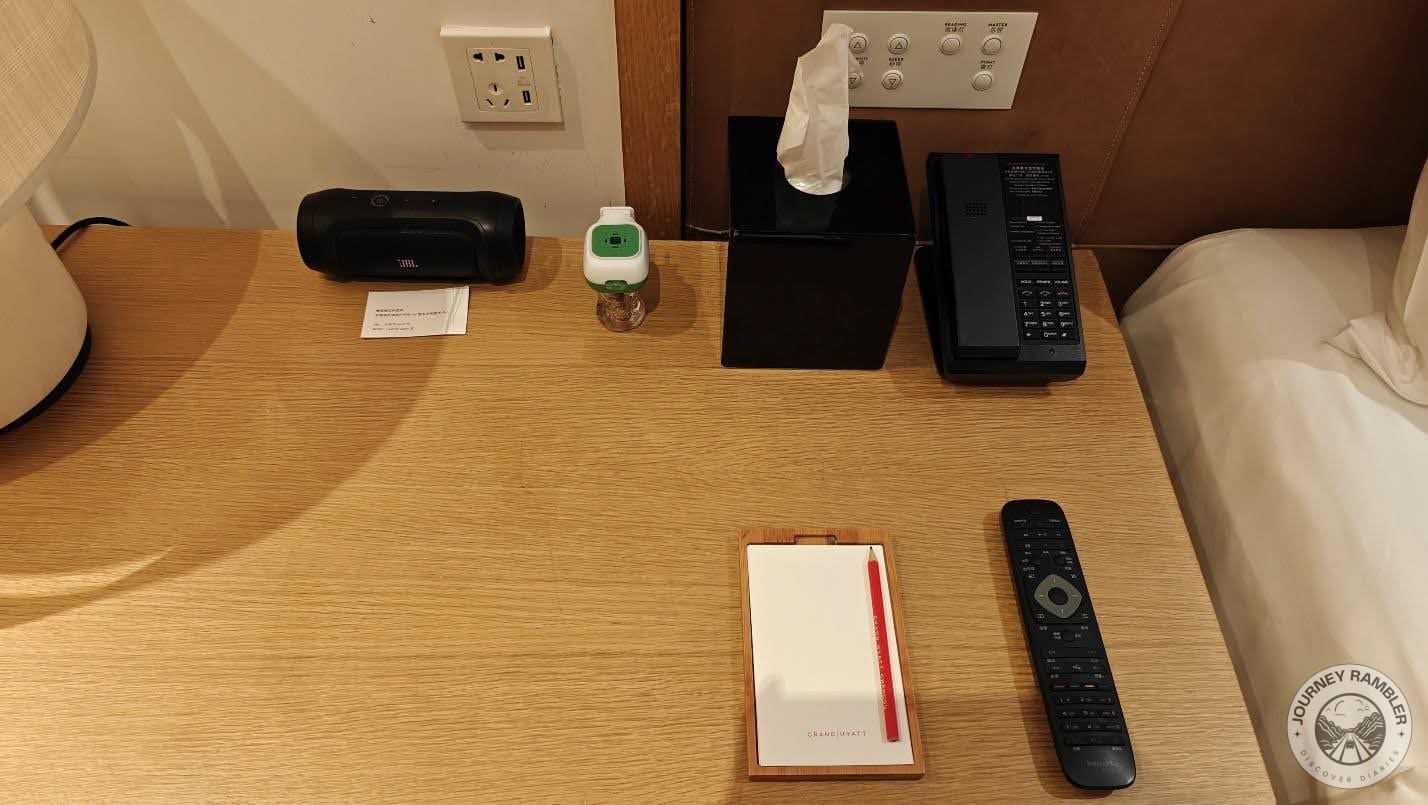 telephone and intercom system, a writing pad, a box of tissues and a digital alarm clock