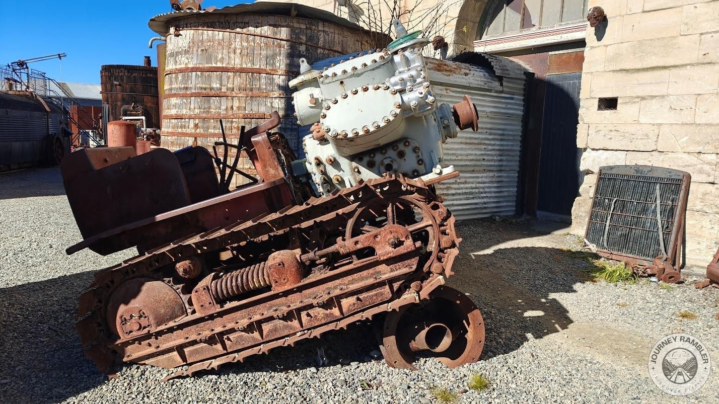 the sculptor of this installation managed to combine an engine with a crawler tractor