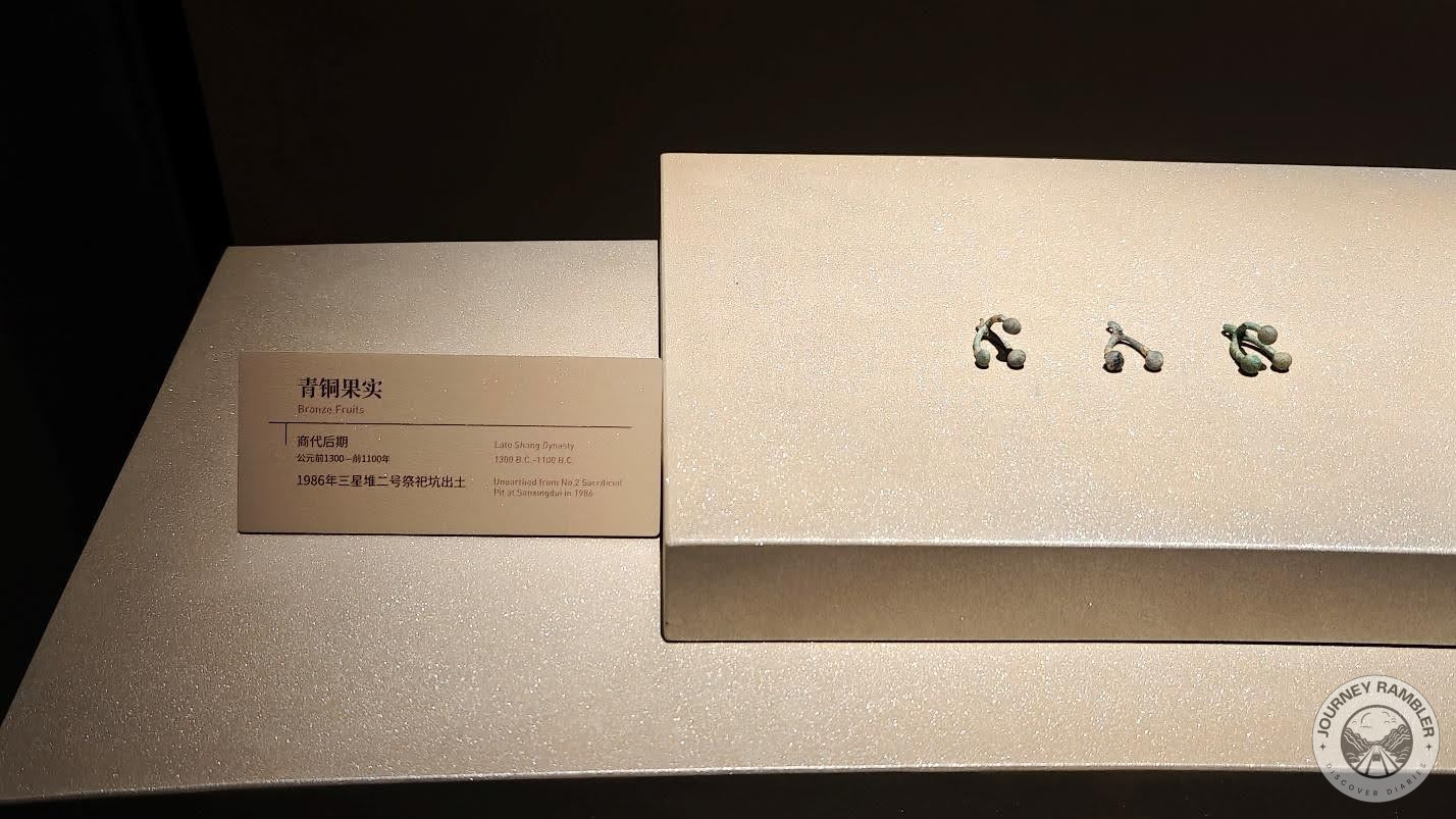 tiny bronze fruits that were displayed in a case