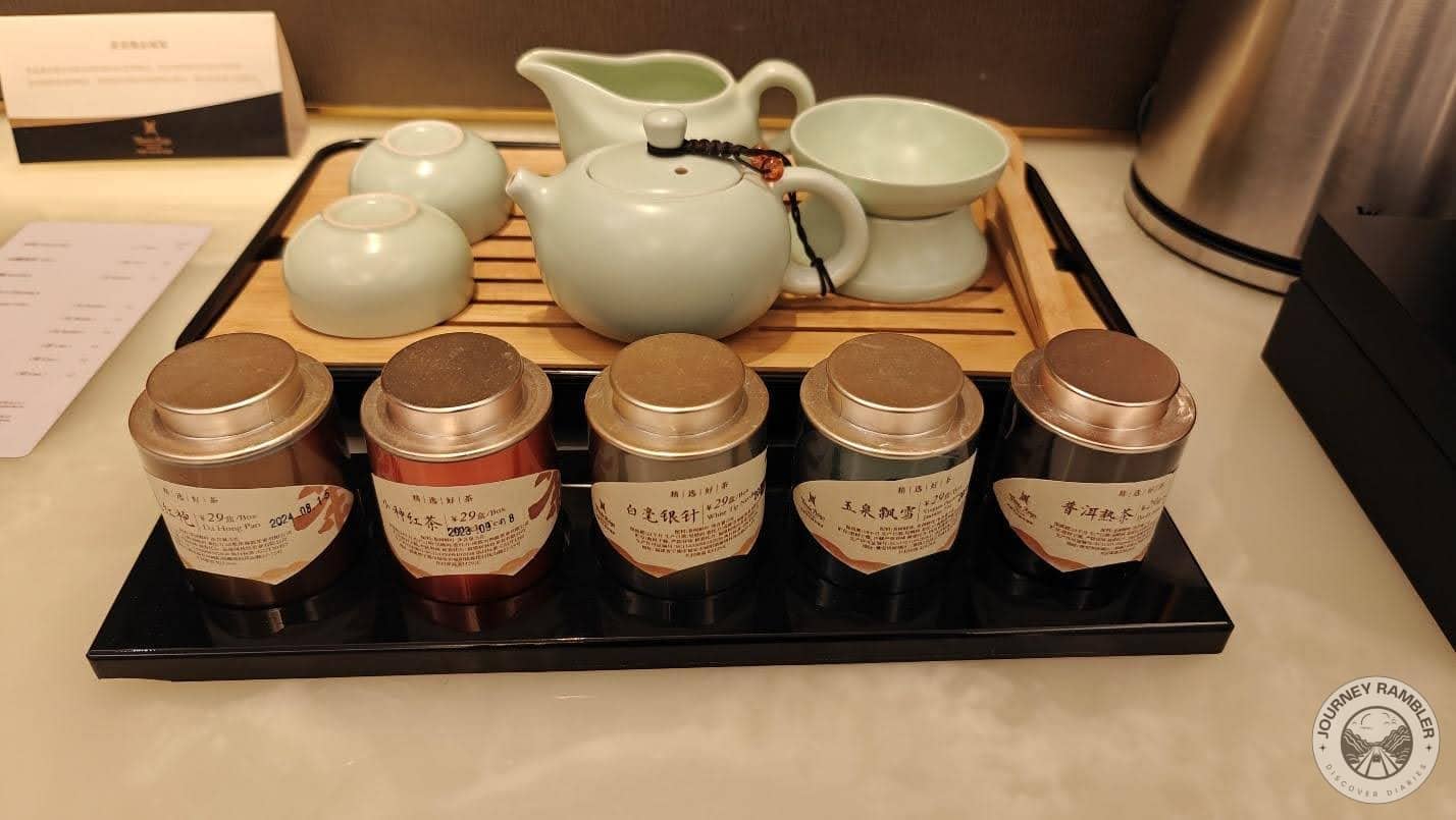 traditional tea set and five different canisters of tea leaves