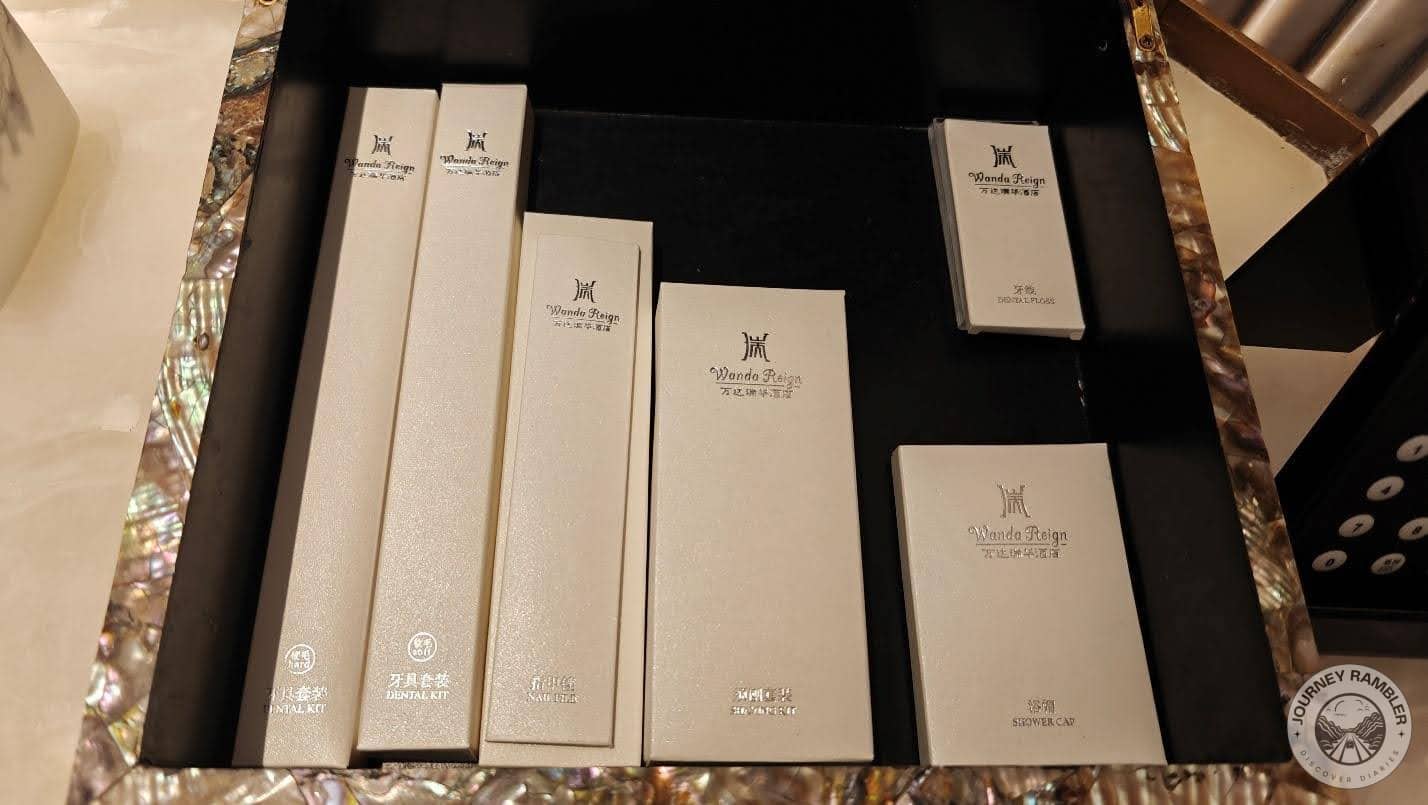 tray with a mother-of-pearl edge held dental kits, shower caps and other such necessities