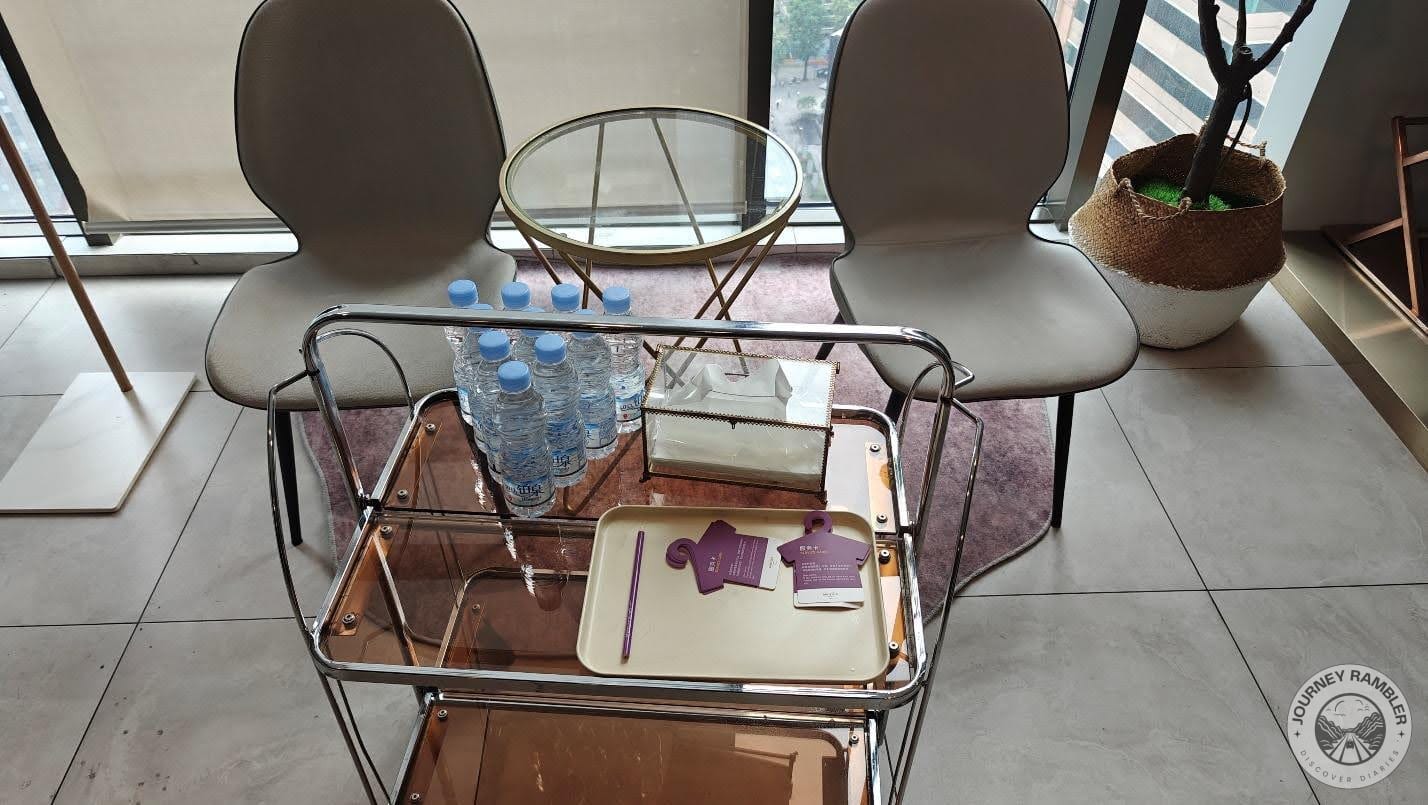 two chairs and a table filled with water bottles