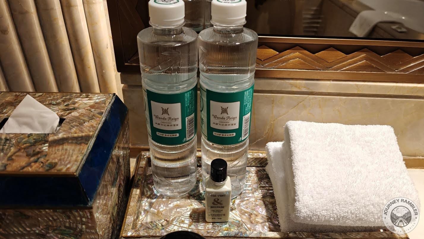 two large bottles of water, hand towels, lotion and a box of tissue