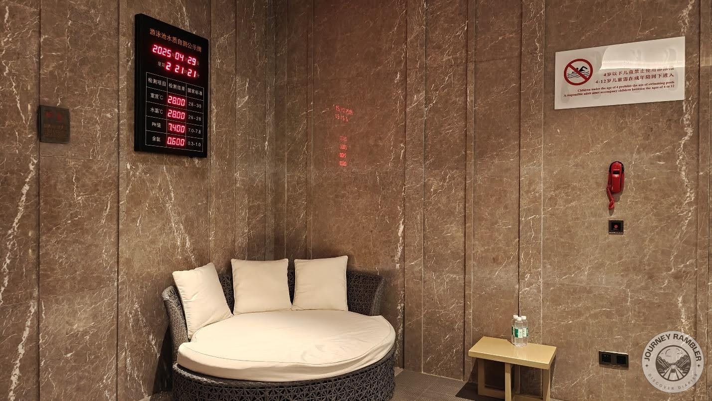 very comfortable looking day bed in one corner, with a small table and a clock nearby